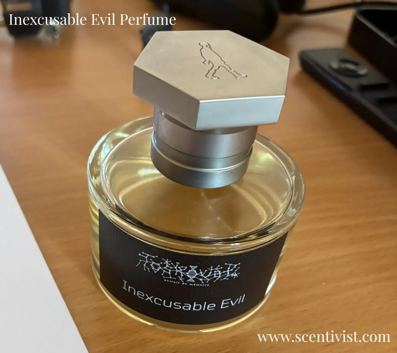 Inexcusable Evil perfume bottle placed on a wooden table with soft lighting highlighting its dark and mysterious design.