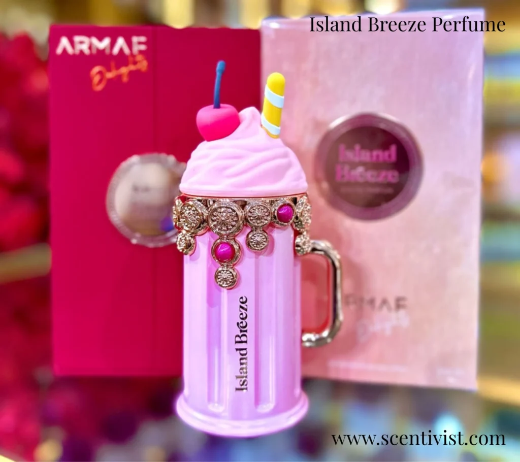Island Breeze perfume bottle with a pink tropical drink–inspired design, featuring gold accents, a cherry garnish, and straw-style cap.