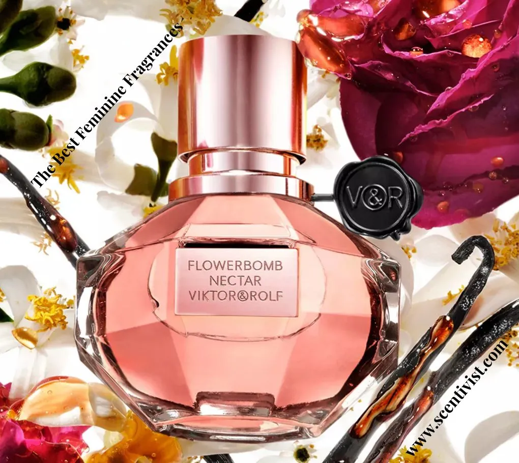 The best feminine fragrances; Viktor & Rolf Flowerbomb Nectar perfume bottle surrounded by roses, vanilla pods, and floral elements on a bright background.