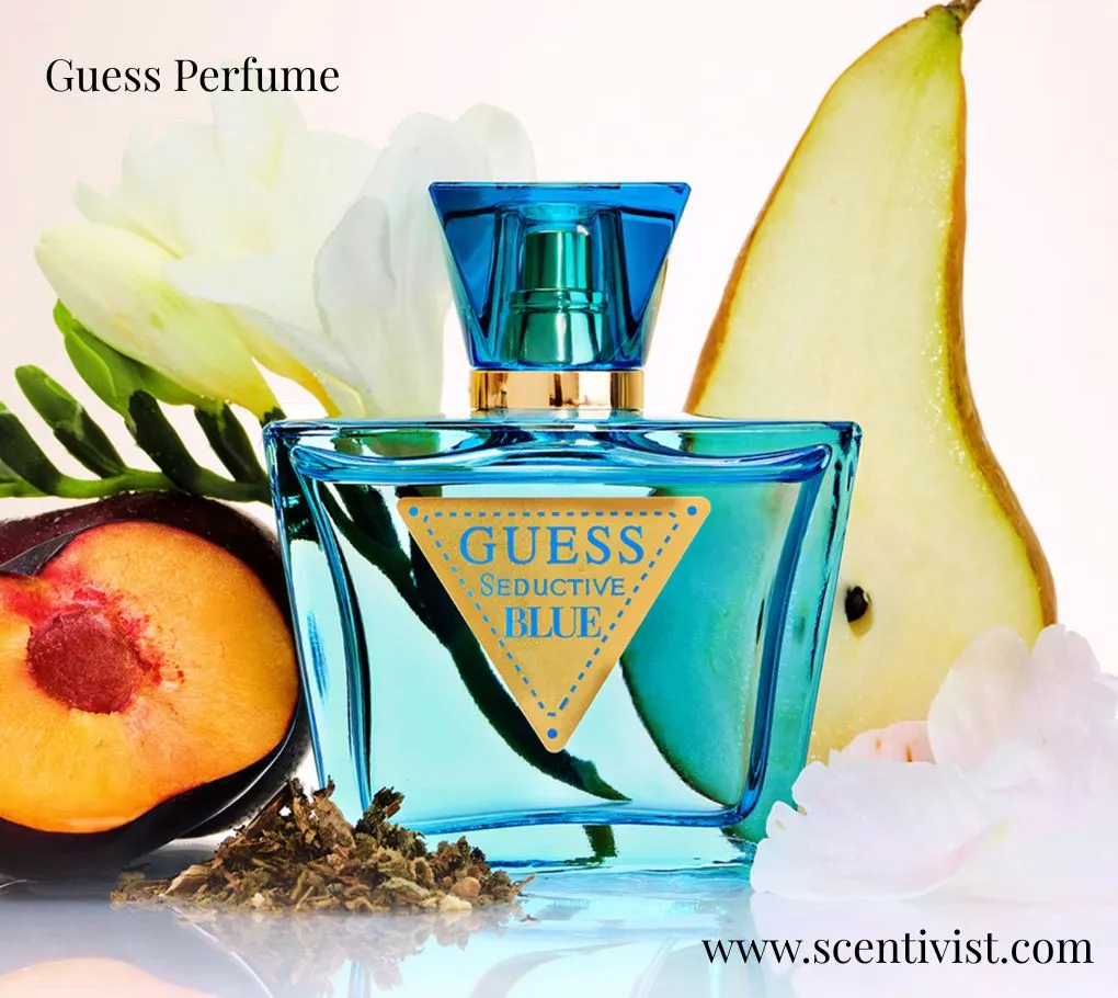 Guess Perfume Seductive Blue bottle in turquoise glass surrounded by pear, peach, flowers, and herbal elements.