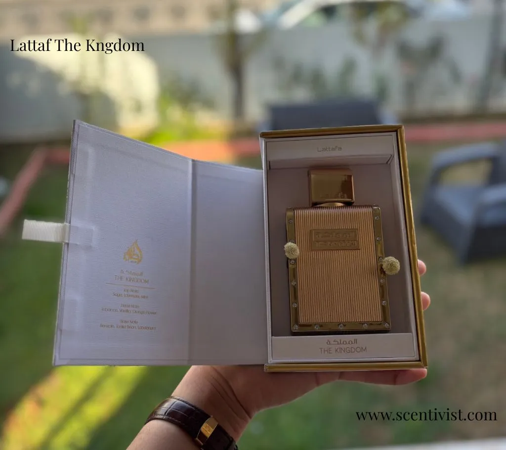 Luxurious golden box of Lattafa The Kingdom perfume with intricate design patterns and embossed lettering.