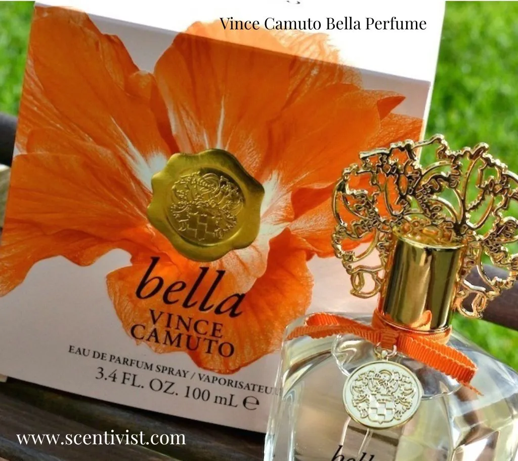 Vince Camuto Bella perfume bottle with gold cap placed in front of its box featuring a large orange flower design.